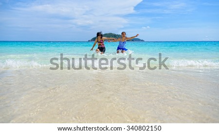 Mother and daughter in a swimsuit playing on the blue sea near the beach with happiness during summer at Koh Miang Island, Mu Ko Similan National Park, Phang Nga, Thailand, 16:9 widescreen