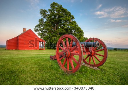 Cannon at Saratoga National Battlefield with Neilson Farm in the background.  Royalty-Free Stock Photo #340873340