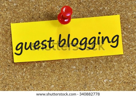 guest blogging word on yellow notepaper with cork background.