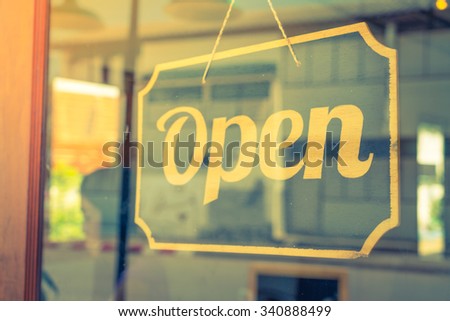 Open sign on a glass door ( Filtered image processed vintage effect. )