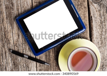 Workspace with coffee cup, tablet pc on old wooden table