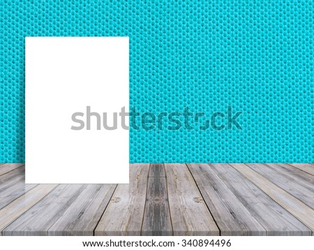 Blank white poster leaning at tropical wood table top with cloth wall,Mock up background for adding your content.