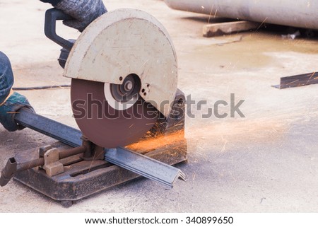 closeup on electric saw and hands of worker with sparks. man working with grinder, close up on tool, sparks fly, real situation picture