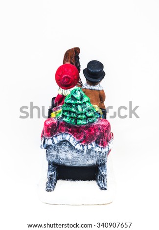 boy and girl riding the Horsecar ,Christmas decoration ceramics, earthenware isolated on white background.