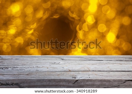wooden table over golden bokeh background, use for text or picture, chirstmas and new year concept