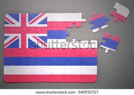 broken puzzle with the flag of hawaii state on a gray background