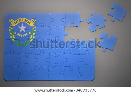 broken puzzle with the flag of nevada state on a gray background