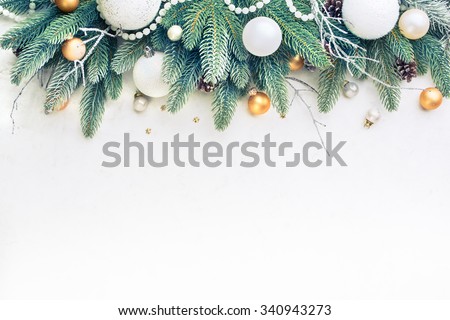 Christmas Tree Pine Branches and Christmas balls on a light background. Royalty-Free Stock Photo #340943273