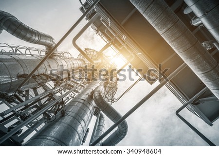 equipment and pipeline in oil refinery in clear sky Royalty-Free Stock Photo #340948604