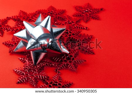 Close up silver ribbon on the red snowflake ornaments, use for Christmas and New year relate. 