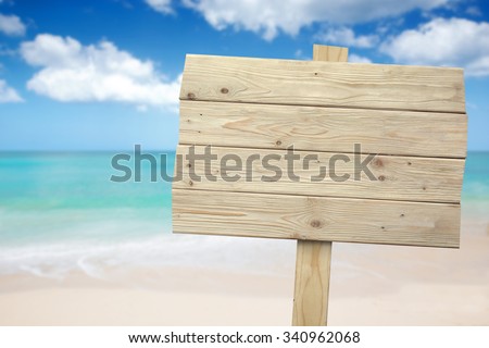 A portrait of a vintage rustic wooden sign on the beach