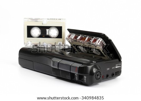 the small cassette recorder with a micro cassette on white background
