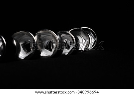 Set of chrome wrenches on black background. Close up.