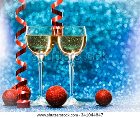 two glasses of champagne ready for christmas celebration, on blue background