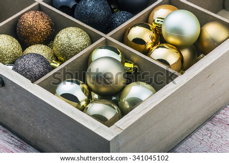 Wooden box filled with christmas balls 