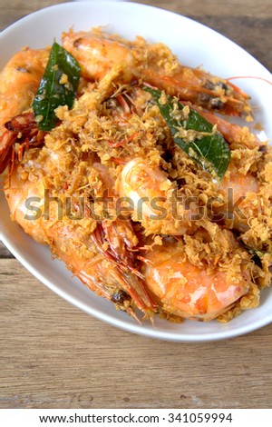 Fried Butter prawn with cereal served on wooden table background. famous food in south east asian