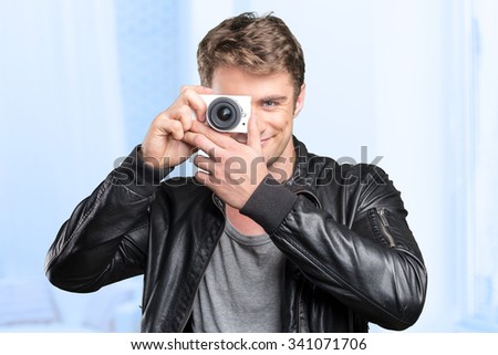 Young man doing a shot with a camera