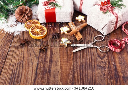 Christmas background. Handmade gift boxes near Christmas tree with cookies and spices. Top view horizontal. Mock up for design greeting card. Selective focus.