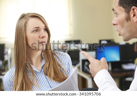 Aggressive Businessman Shouting At Female Colleague