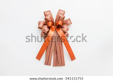 Brown and orange ribbon with bow on white background for christmas and new year