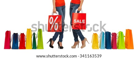 people, sale and discount concept - close up of women with percentage sign on red shopping bag