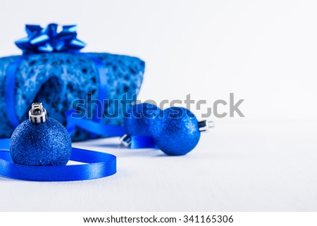 Christmas gift with blue balls on white background