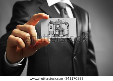 Businessman with house picture, concept real estate
