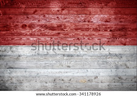 A vignetted background image of the flag of Indonesia painted onto wooden boards of a wall or floor.