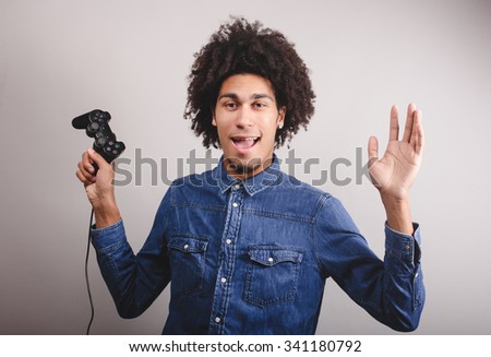 man playing video game with wireless joystick