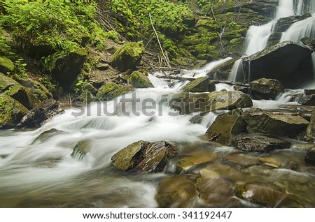 Mountain fast flowing river Shipot waterfall stream of water in the rocks