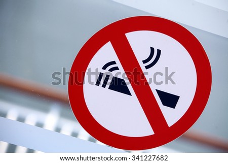 Color image of a 'No Smoking' sign on a window.