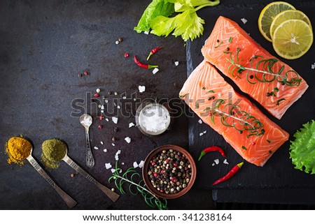 Raw salmon fillet and ingredients for cooking on a dark background in a rustic style. Top view Royalty-Free Stock Photo #341238164