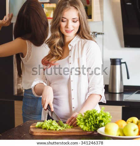 Group of young women in a kitchen room preparing food