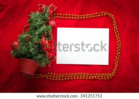Design a Christmas greeting card with white paper on a red background.