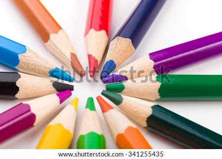 Many different colored pencils on white background.
