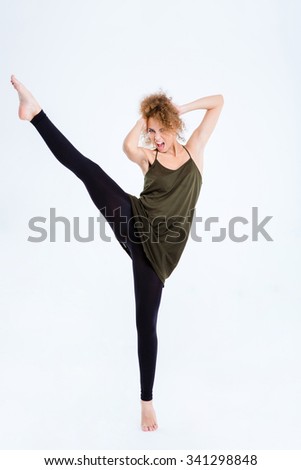 Portrait of a young excited female ballerina posing isolated on a white background