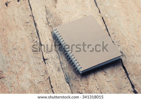 notebook with space on old wooden -vintage effect.