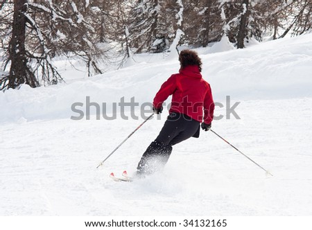 A woman is skiing at a ski resort
