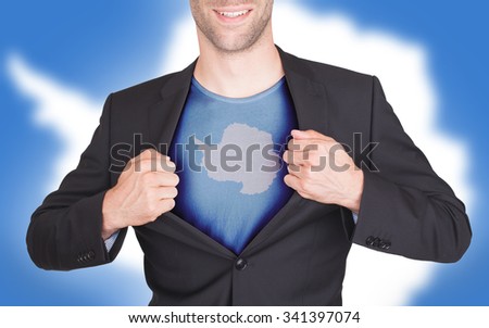 Businessman opening suit to reveal shirt with flag, Antarctica