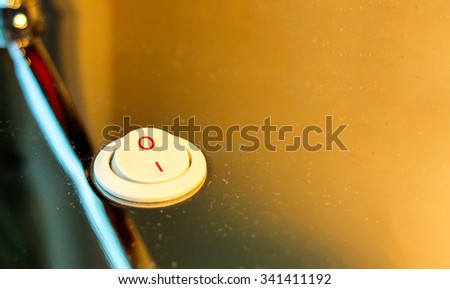 Turn The Light Off Concept, Electronic Light Switch at Corner in Turn On Stage with Orange Lamp Shade on Stainless Background as Copyspace to input Text used as Template