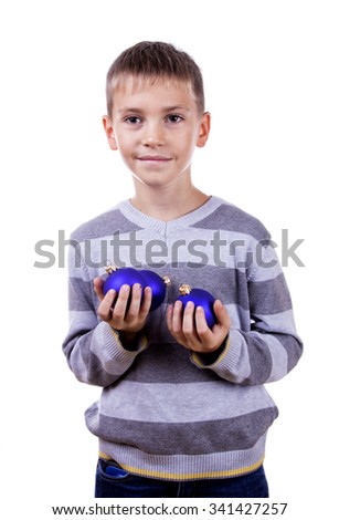 Cute blond boy holding a Christmas toy. Isolated on white background.