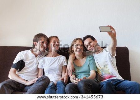 group of friends taking photo of themselves, home party, selfy
