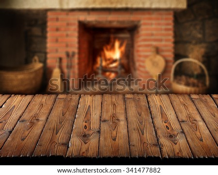 wooden slats table in front of fireplace,winter background