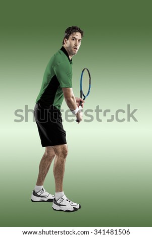 Tennis player with a green shirt, playing on green background.