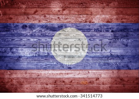 A vignetted background image of the flag of Laos painted onto wooden boards of a wall or floor.