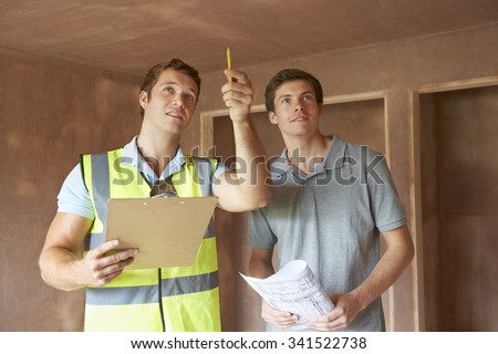 Builder And Inspector Looking At New Property Royalty-Free Stock Photo #341522738
