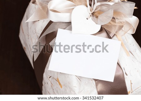 In the picture a gift bag with copy space on the wooden background.