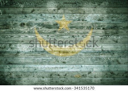 A vignetted background image of the flag of Mauritania painted onto wooden boards of a wall or floor.