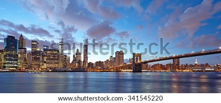 The Brooklyn Bridge and Manhattan skyline as seen from across the East River at dusk. New York City at night