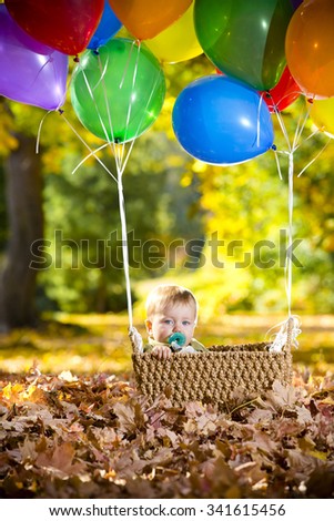 Baby boy in balloon basket